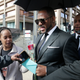 Fans giving singer R. Kelly a rose, and cards, outside the Leighton Courthouse on March 22, 2019 in Chicago, Illinois.